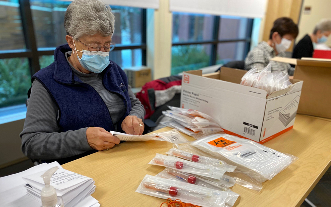 Volunteer assembling COVID kits
